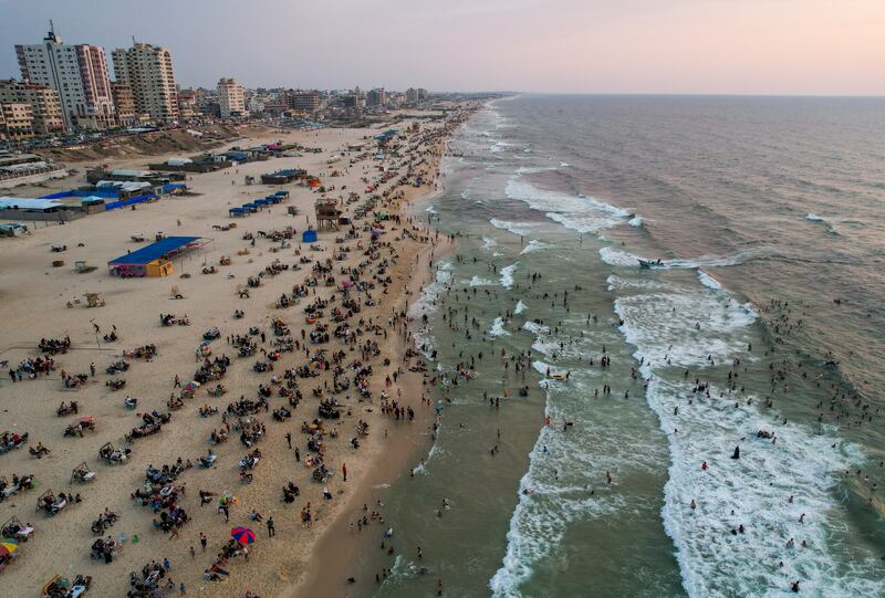 People enjoy a hot day on the beach in Gaza City. Reuters