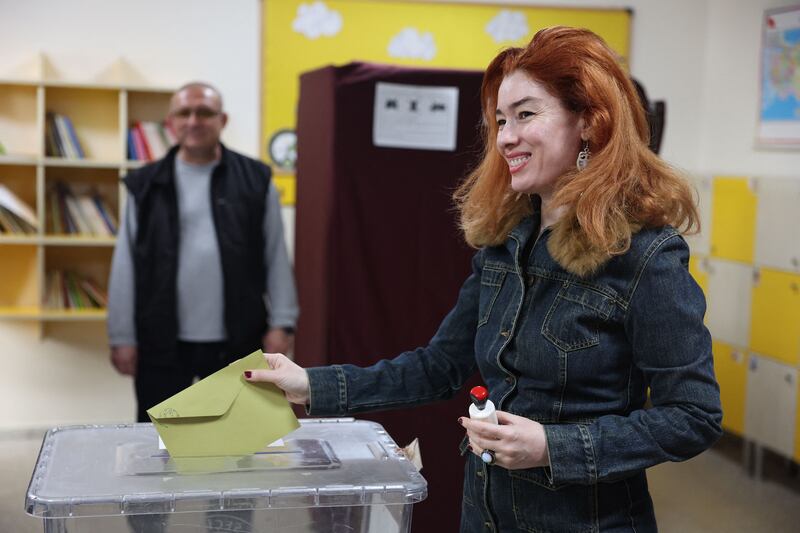A voter casts her ballot at a polling station in Ankara. AFP