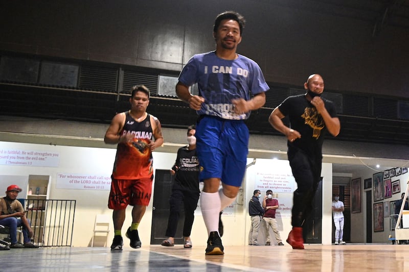 Manny Pacquiao jogs inside a basketball gym near his home in the city of General Santos in southern island of Mindanao for his upcoming bout against Errol Spence.