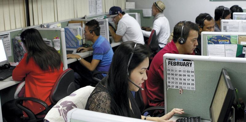 Call center agents work overnight daily to cater to United States clients in Manila's Makati financial district February 6, 2012. The number of Filipinos who work graveyard shifts to answer calls on behalf of big multinational companies like Citigroup and JPMorgan Chase is now greater than India's 350,000, earning the Philippine's the title - Call Centre Capital of the World. By 2016, the Philippines wants to double the size of the local BPO market to $25 billion, employing 1.3 million workers from 640,000 at the end of 2011. But to be able to that the Southeast Asian nation must convince investors it has more to offer than a huge pool of english-speaking talent. Picture taken February 6, 2012. To match Analysis OUTSOURCING/PHILIPPINES   REUTERS/Erik De Castro (PHILIPPINES - Tags: BUSINESS EMPLOYMENT) - GM1E8381AD401