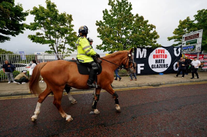 Police keep watch outside the ground ahead of an organised protest. Getty