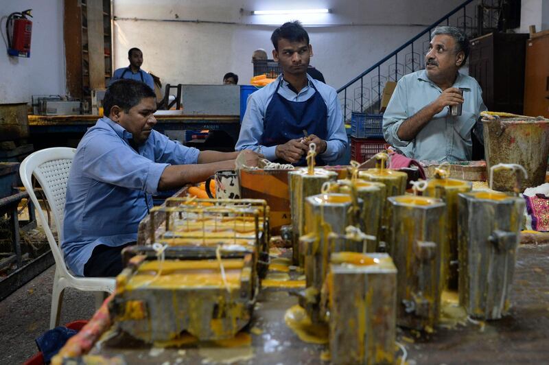 Visually impaired workers make candles in a workshop of the Blind School Relief Association in New Delhi on October 16, 2019. The association sells candles, oil lamps and paper products made by visually impaired trainees and workers ahead of Hindu festival 'Diwali,' or the festival of light. AFP / Sajjad Hussain