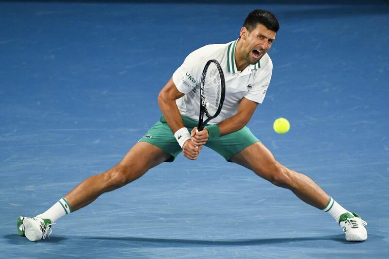 epa09012093 Novak Djokovic of Serbia in action during his men's singles fourth round match against Milos Raonic of Canada at the Australian Open Grand Slam tennis tournament at Melbourne Park in Melbourne, Australia, 14 February 2021.  EPA/DAVE HUNT  AUSTRALIA AND NEW ZEALAND OUT