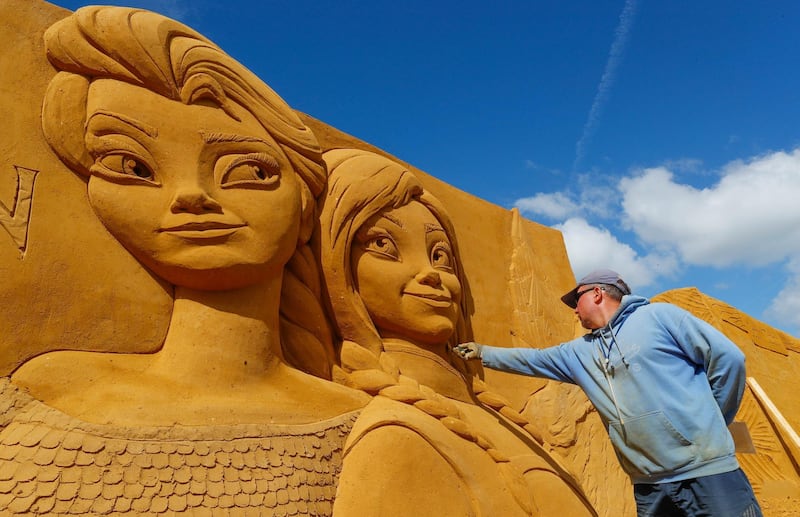 A sand carver works on a sculpture during the Sand Sculpture Festival 'Disney Sand Magic' in Ostend, Belgium. Yves Herman / Reuters