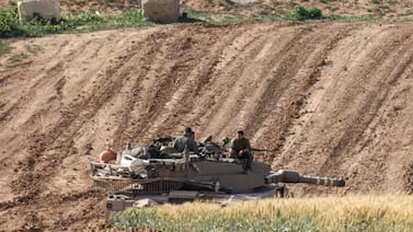 Israeli soldiers sit on top of a tank along the border with Gaza. AFP