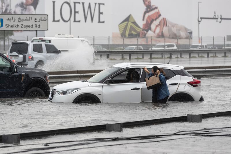 A motorist's car is stranded on a flooded Dubai road, following torrential rain. Antonie Robertson / The National