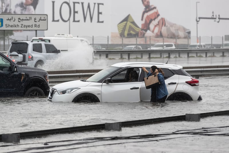 A motorist's car is stranded on a flooded Dubai road, following torrential rain. Antonie Robertson / The National