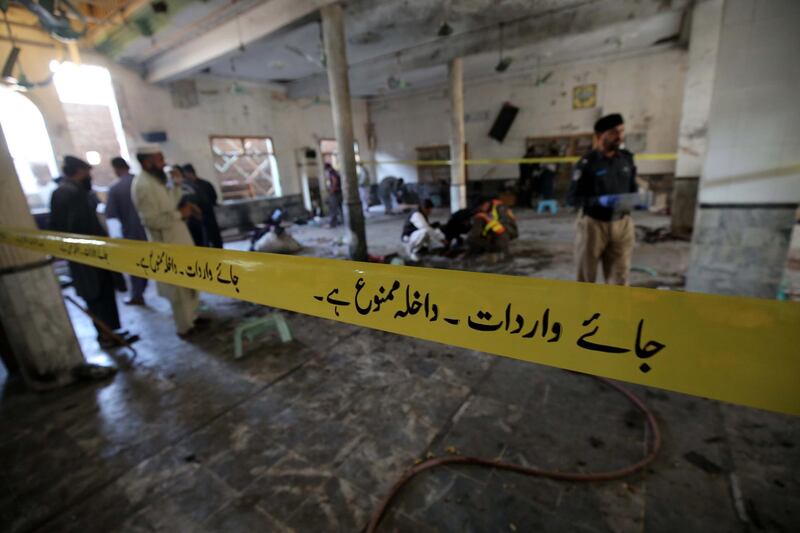 Security officials inspect the scene of an explosion at an Islamic seminary in Peshawar, Pakistan.  EPA