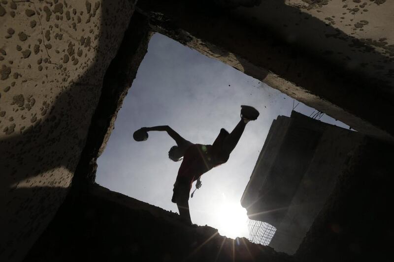 A Filipino jumps on top of burnt homes following an overnight fire that razed a slum area in Caloocan city, east of Manila, Philippines. One person died, one more is missing, and thousands of families lost their homes on Easter Sunday after several fire hit residential areas in Metro Manila. Investigators said the result of an initial investigation pointed to electrical short circuit as the cause of the blaze. Francis R. Malasig /EPA