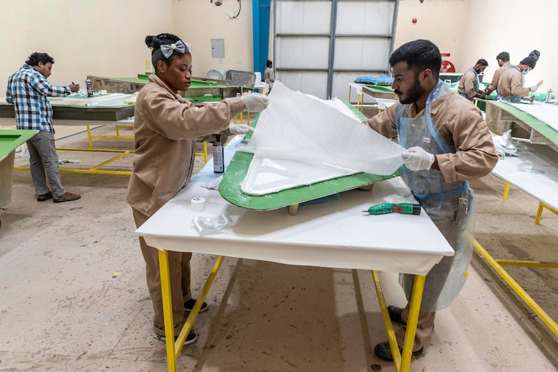 Employees work on fabrication of fibreglass frames of yachts. Antonie Robertson / The National 
