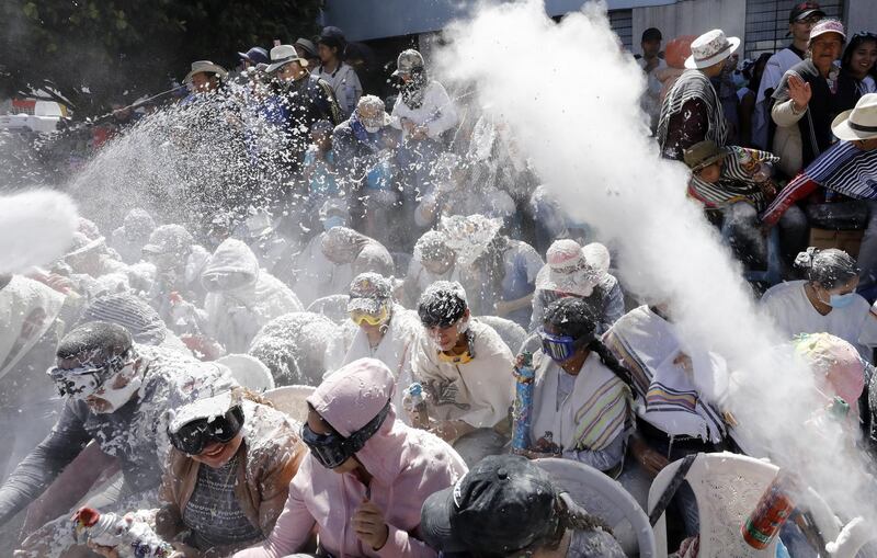 Attendees play with foam during the Grand parade of the Blancos y Negros Carnival, in Pasto, Colombia.  EPA