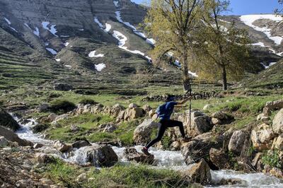 Nayla Cortas crosses a stream near Bcharri whilst traversing the Lebanon Mountain Trail. Matt Kynaston for The National