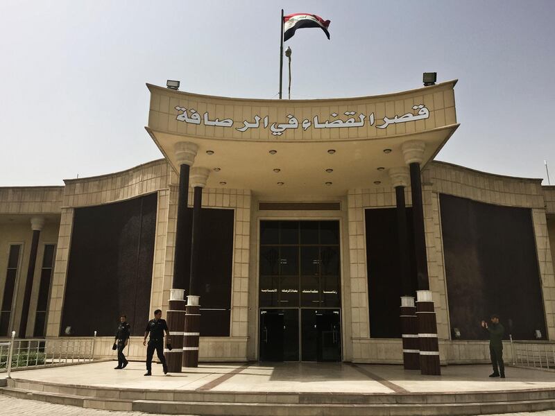 FILE - in this May 23, 2018 file photo, security guards stand outside the building where Islamic State militants are tried in a special counterterrorism court in Baghdad, Iraq. A Baghdad court sentenced to death three French citizens Sunday for being members of the Islamic State group, an Iraqi judicial official said. The official said the three were among 12 French citizens handed over to Iraq in January by the U.S.-backed Syrian Democratic Forces. Then SDF has handed over to Iraq hundreds of suspected IS members in recent months. (AP Photo/Maya Alleruzzo, File)