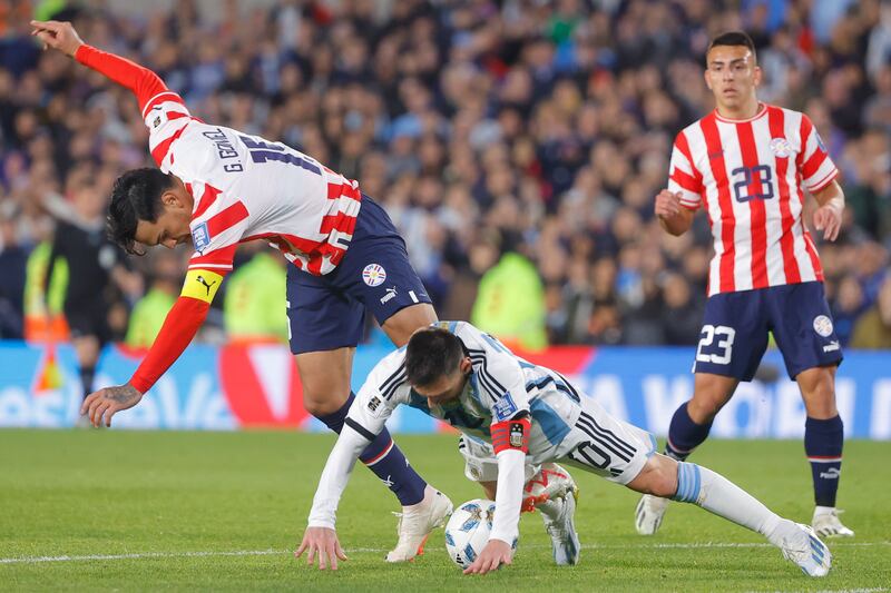 Lionel Messi of Argentina vies for the ball with Gustavo Gomez of Paraguay. EPA