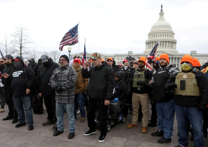 FILE PHOTO: Proud Boys member Joe Biggs (front row second from left in grey plaid shirt) poses with other members before he was later arrested for involvement in the storming of the U.S. Capitol building in Washington. D.C., U.S. Picture taken January 6, 2021. REUTERS/Jim Urquhart/File Photo