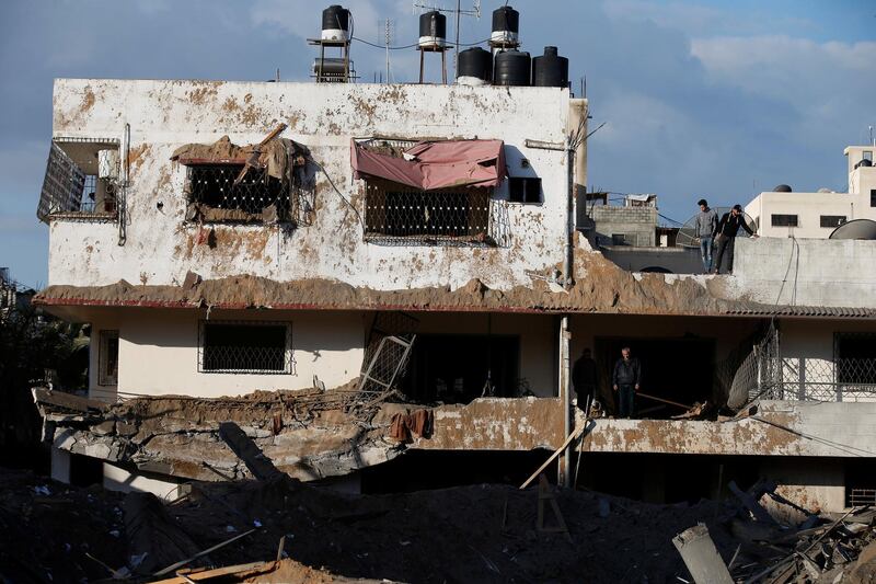 Palestinians inspect their house that was damaged in a nearby Israeli air strike in Gaza City. Reuters