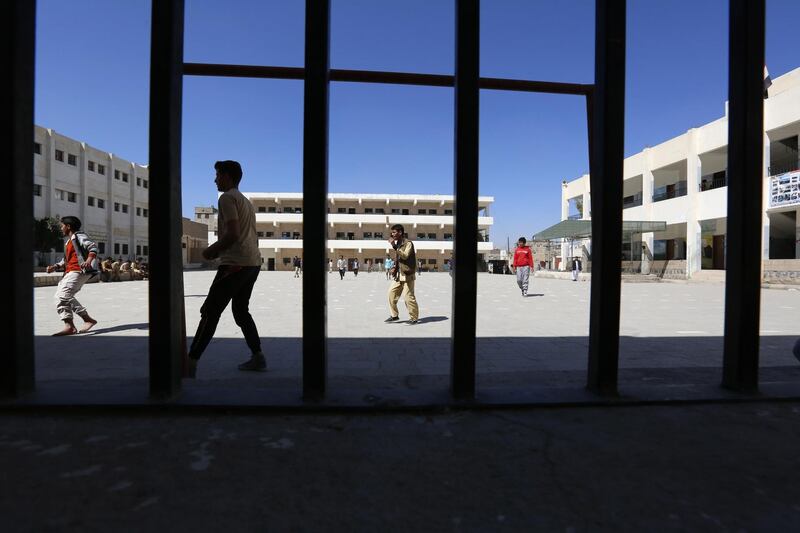 Yemeni students play football in the playground of a school at break time in Sana'a. EPA
