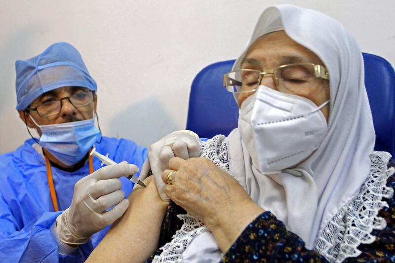 A woman receives the Sputnik-V COVID-19 vaccine at a vaccination center in Blida, south of Algiers, Algeria, Saturday, Jan. 30, 2021. The vaccines were delivered to the Boufarik military airport west of Algiers, Minister Amar Belhimeur said in a statement. He did not indicate how many arrived, though the government had said it had ordered a first batch of 500,000 Sputnik doses. (AP Photo/Fateh Guidoum)