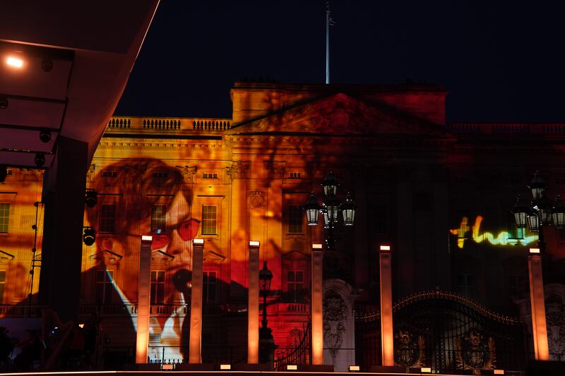 Sir Elton John performs by video link beamed onto the facade of Buckingham Palace.