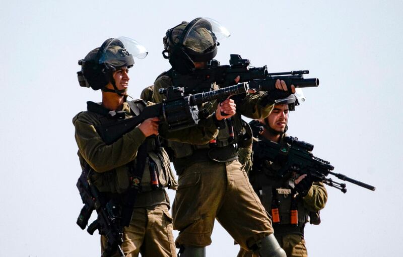 Israeli security forces fire tear gas during clashes with Palestinian protesters following a demonstration against the expansion of settlements, near the village of Beit Dajan, east of Nablus in the occupied West Bank, on February 6, 2021. International law regards all settlements built on occupied Palestinian land, whether public or privately owned, as illegal. / AFP / JAAFAR ASHTIYEH
