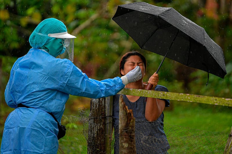 A health worker collects a nasal swab sample to test for Covid-19 to a resident, in Arraijan District, 23 km west of Panama City.  AFP