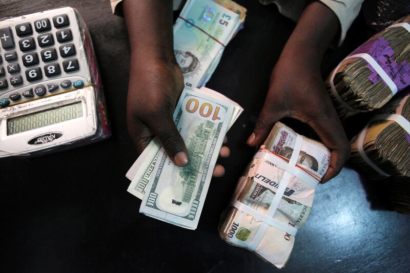 Dollar and naira bills at a currency exchange in Lagos, Nigeria. The greenback's strength against the Nigerian currency has pushed the price of garments and other foreign goods beyond the reach of many local consumers. Reuters