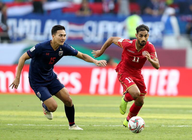 Dubai, United Arab Emirates - January 10, 2019: Ali Jaafar Madan of Bahrain and Suphan Thongsong of Thailand battle during the game between Bahrain and Thailand in the Asian Cup 2019. Thursday, January 10th, 2019 at Al Maktoum Stadium, Abu Dhabi. Chris Whiteoak/The National