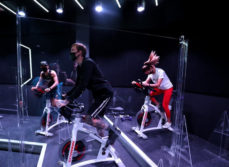 Dubai, United Arab Emirates - Reporter: N/A: News. Covid-19/Coronavirus. Maria, Fraz and Nuno (L) work out. Crank an Indoor Cycling & Boutique Fitness Studio have brought in partitions between bikes to protect their customers from Covid-19. Monday, June 1st, 2020. Dubai. Chris Whiteoak / The National
