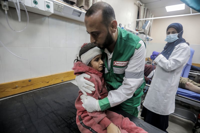 A man consoles a young Palestinian girl at Nasser Medical Hospital, Khan Yunis, Gaza. Getty Images
