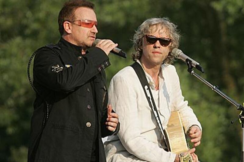 Irish singers Bono and Bob Geldof perform during a concert in Germany. A reader suggests that they turn their attention to the Irish debt crisis.