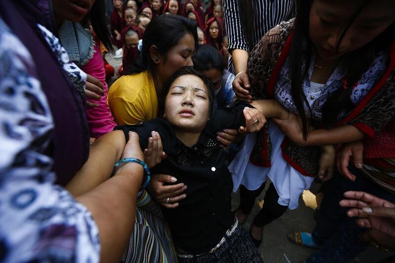 Daughter of Ang Kaji Sherpa, one of the victims of the Mount Everest avalanche on 18 April, collapses during a cremation ceremony at Syambhu in Kathmandu, Nepal. Narendra Shestha / EPA