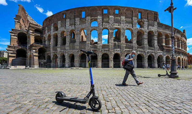 A view shows shared electric scooters parked in front of the Coliseum monument in Rome, as the country eases its lockdown aimed at curbing the spread of the COVID-19.  With deconfinement and good weather, self-service shared electric scooters have invaded the streets of Rome in recent days, a novelty in the Eternal City, which in turn is discovering the joys and nuisances of new forms of mobility.  AFP