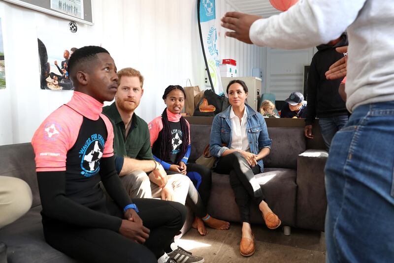 Prince Harry, Duke of Sussex and Meghan, Duchess of Sussex meet surf mentors as they visit Waves for Change, an NGO, at Monwabisi Beach in Cape Town, South Africa. Waves for Change supports local surf mentors to provide mental health services to vulnerable young people living in under resourced communities. Getty Images