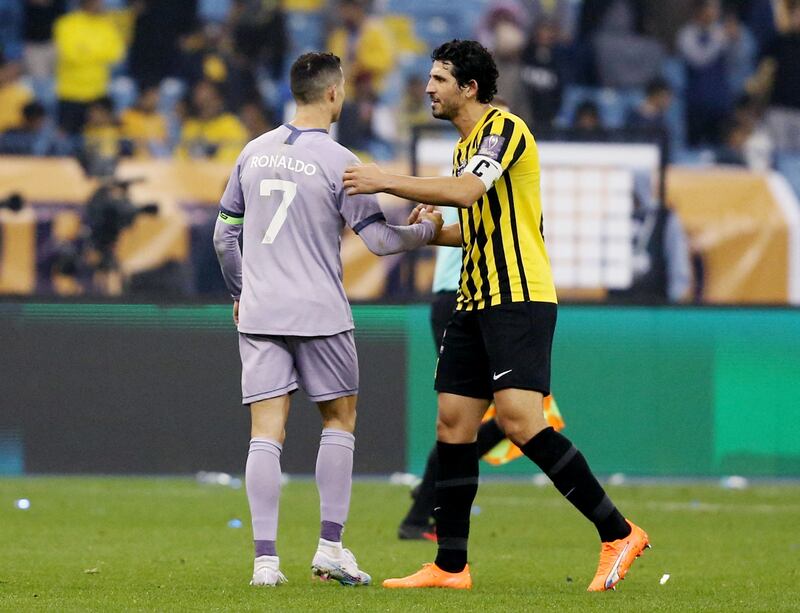 Al Nassr's Cristiano Ronaldo shakes hands with Al Ittihad's Ahmed Hegazy after the match. Reuters
