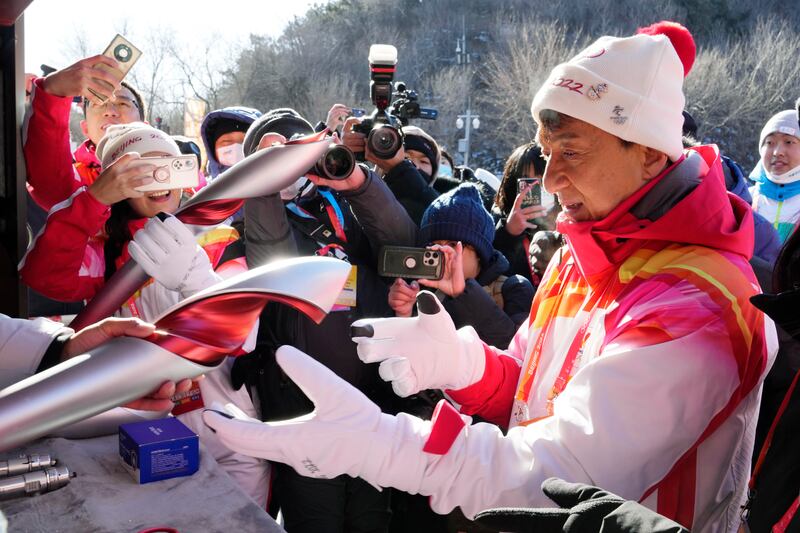 Chan receives a Beijing 2022 Winter Olympics torch as a souvenir after taking part in the relay. AP