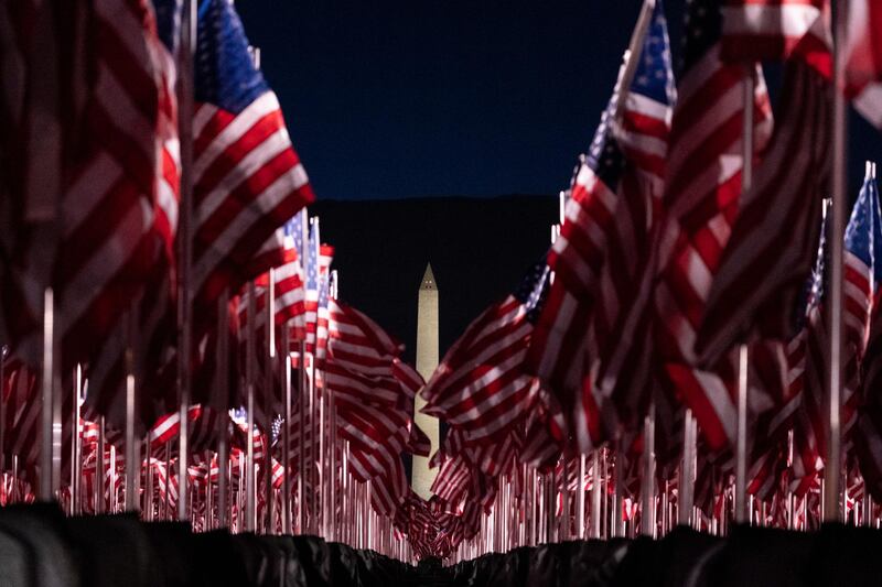 Flags are placed on the National Mall, with the Washington Monument behind them, ahead of the inauguration of President-elect Joe Biden and Vice President-elect Kamala Harris, in Washington. AP Photo