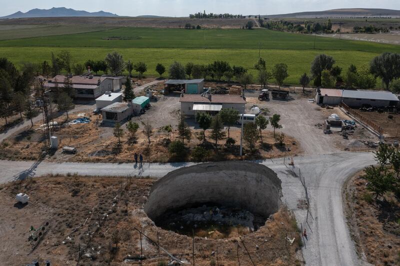 A sinkhole into which part of a road has collapsed in the village of Ekmekci, near Karapinar.