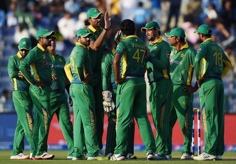 Pakistan celebrate a wicket during the second one day international match against England at Zayed Cricket Stadium in Abu Dhabi, United Arab Emirates, Friday, Nov. 13, 2015. (AP Photo/Hafsal Ahmed)