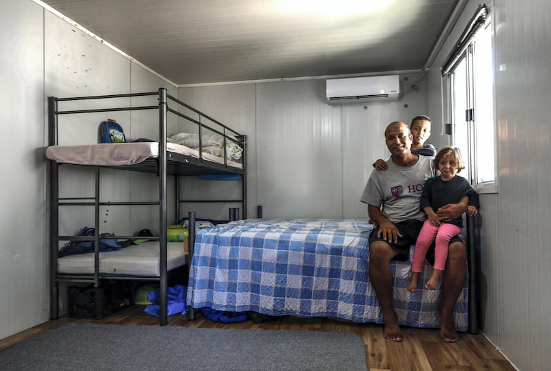 Mytilene, Greece, September 12, 2018.  The Kara Tepe refugee camp.  Saeed from Afghanistan with his children Zahra-3 and Yousef-9 in their camp quarters at Kara Tepe refugee camp.
Victor Besa/The National
Section:  WO
Reporter:  Anna Zacharias