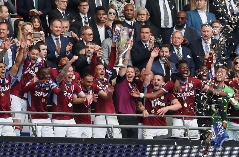 Aston Villa's Jack Grealish and teammates lift trophy as they celebrate winning the playoffs. Reuters