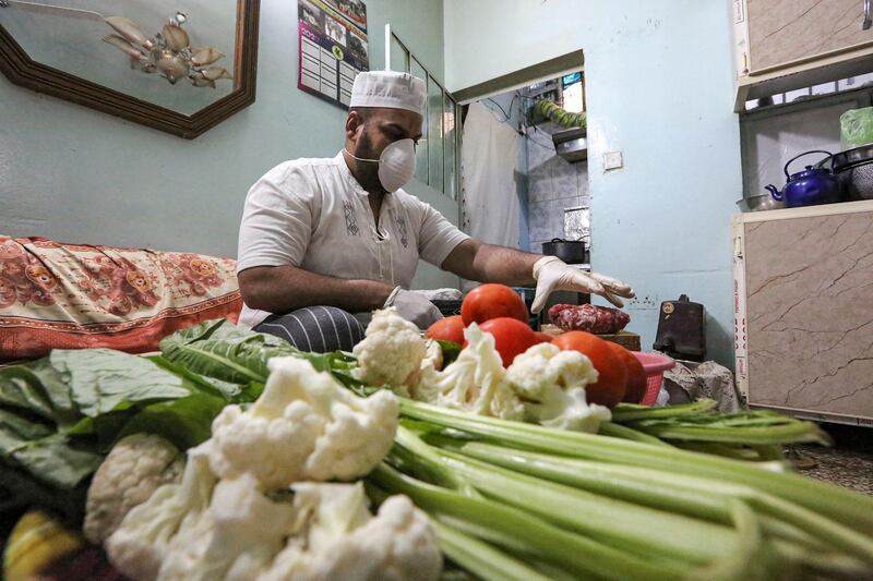A cook prepares food for a family currently under lockdown in the Iraqi capital Baghdad. AFP