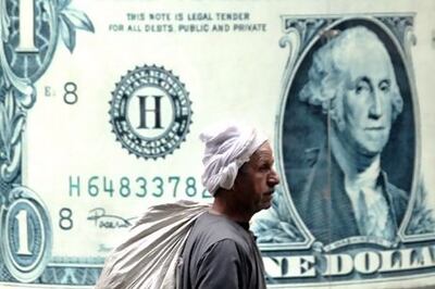 A man walks past the window of an exchange bureau in Cairo, Egypt. AP