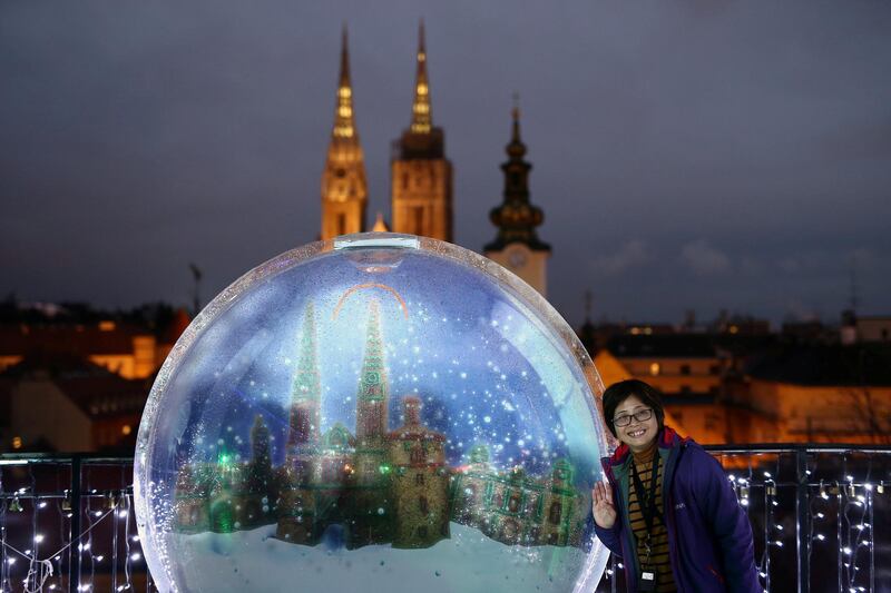 A tourist poses for a picture during the Christmas market in Zagreb, Croatia. Antonio Bronic / Reuters