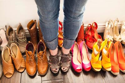 Caucasian woman trying on shoes. Getty Images