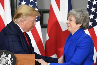 US President Donald Trump shakes hands with Theresa May. Bloomberg