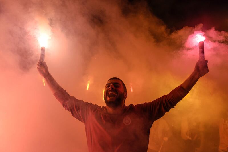 A Galatasaray supporter celebrates their 2017-2018 championship title at Florya Metin Oktay in Istanbul. Yasin Akgul / AFP