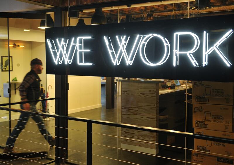 (FILES) This file photo taken on March 13, 2014 shows a man entering the doors of the "WeWork" co-operative co-working space in Washington, DC. 
Office-sharing startup WeWork on November 28, 2017 announced a deal to buy Meetup, an online social network devoted to organizing real-world activities based on common interests.Financial terms of the deal were not disclosed, but news website Axios cited a source as saying it was valued at about $200 million. New York-based Meetup has grown to 35 million members since it launched in June of 2002, according to WeWork.
 / AFP PHOTO / MANDEL NGAN