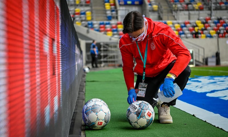 Balls are disinfected at the Dusseldorf-Paderborn game. Reuters