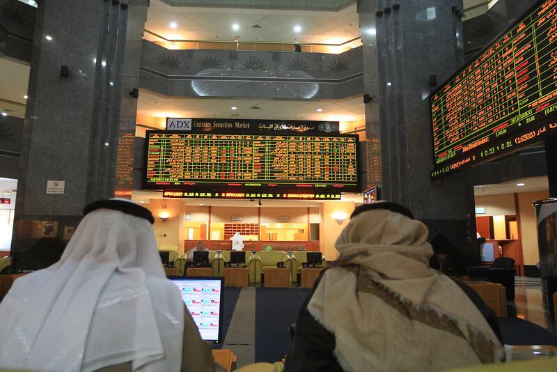 ABU DHABI - UNITED ARAB EMIRATES - 14JAN2013 - Share holders watch the display of share market at (ADX) Abu Dhabi Securities Exchange. Ravindranath K / The National 