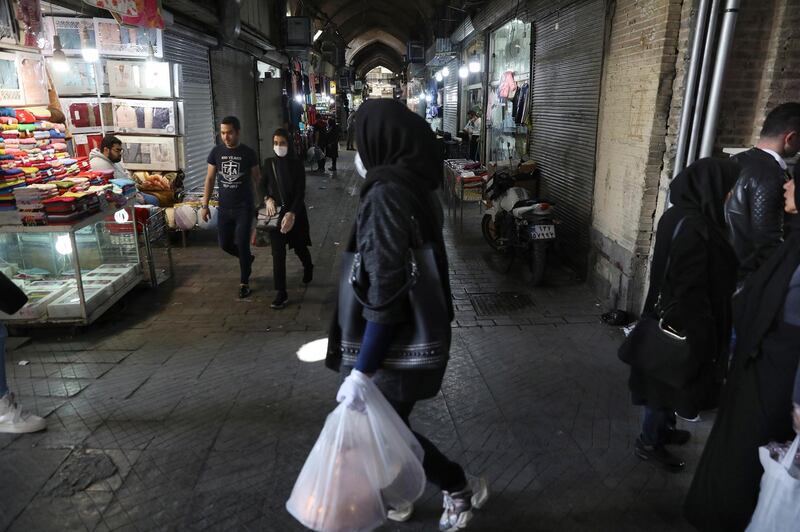 Shoppers walk through the mostly closed Tehran's Grand Bazaar, Iran. AP